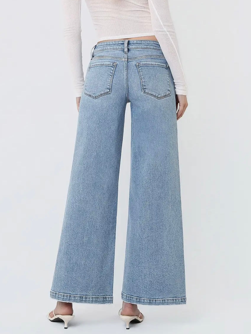 Light blue wide-leg jeans worn by a person on a white background