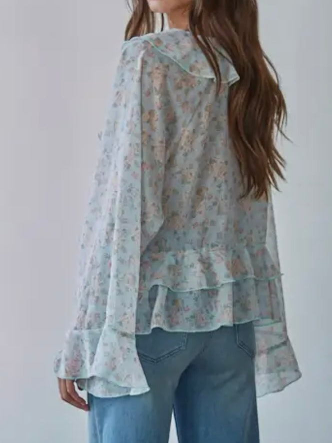 Woman wearing a floral blouse with a plain background