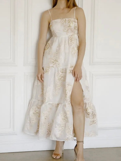 Woman wearing a floral dress with a white paneled wall background