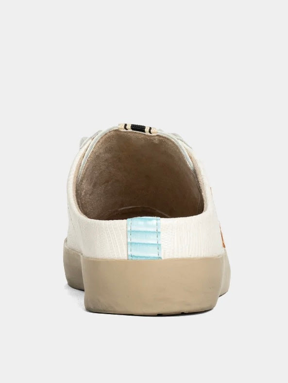 Back view of a beige sneaker with a light blue stripe on a white background