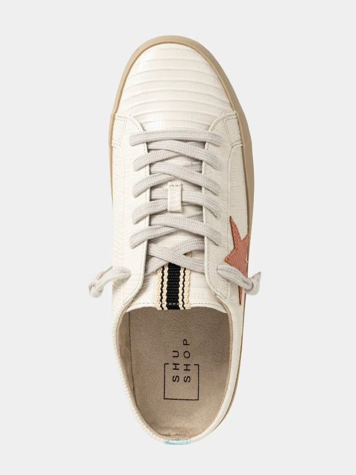 White sneaker with a star detail on a light gray background