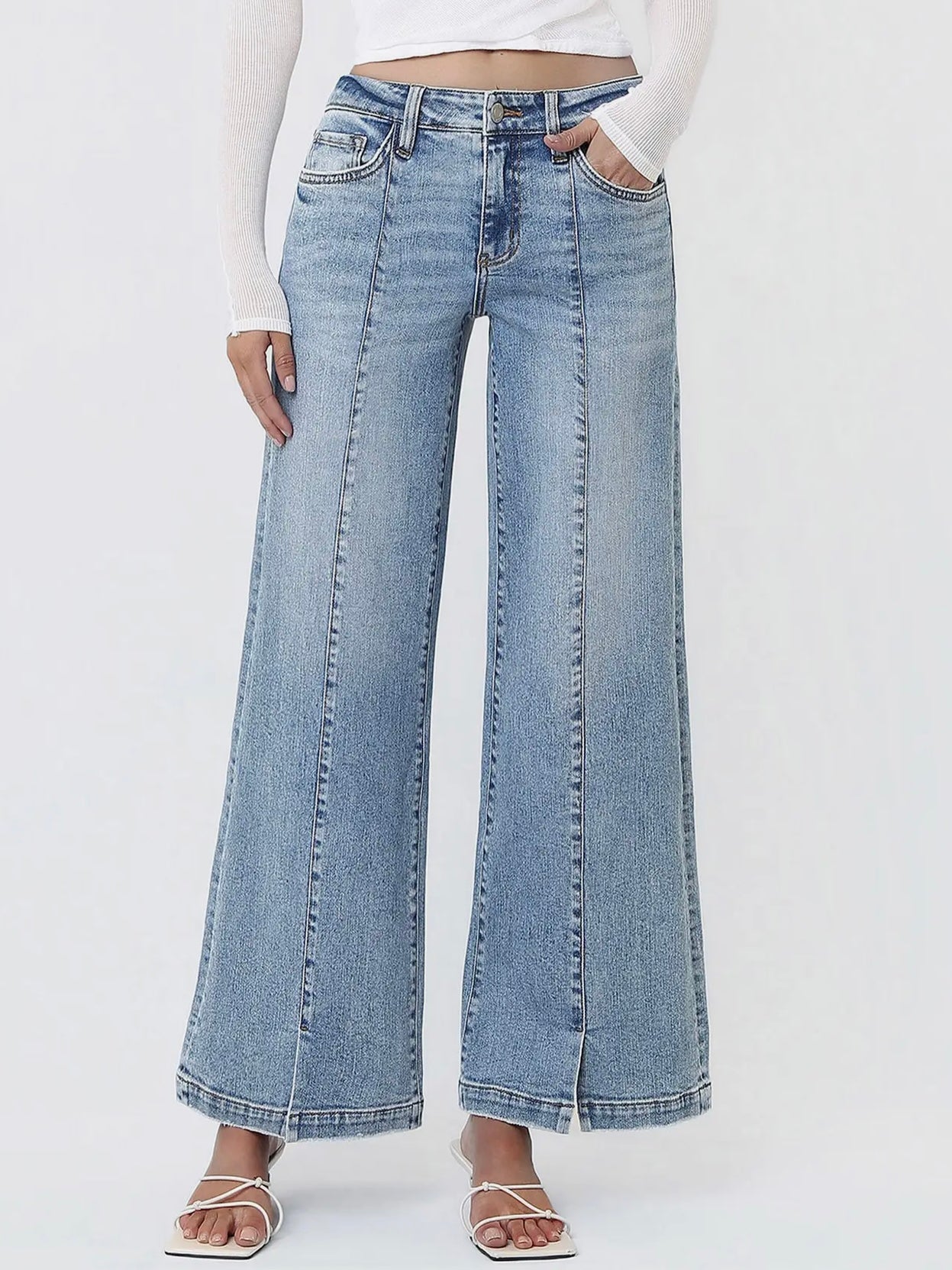 Light blue wide-leg jeans worn by a person on a white background