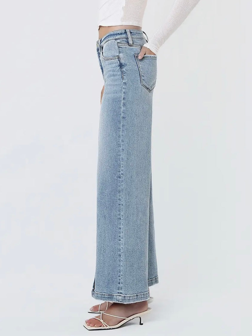 Light blue jeans worn by a person on a white background