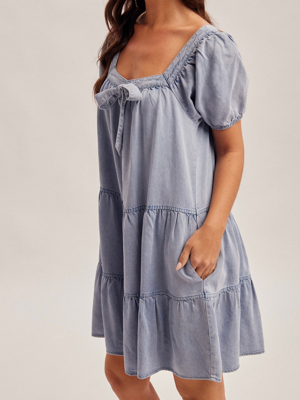 Light blue dress with ruffled details on a plain background