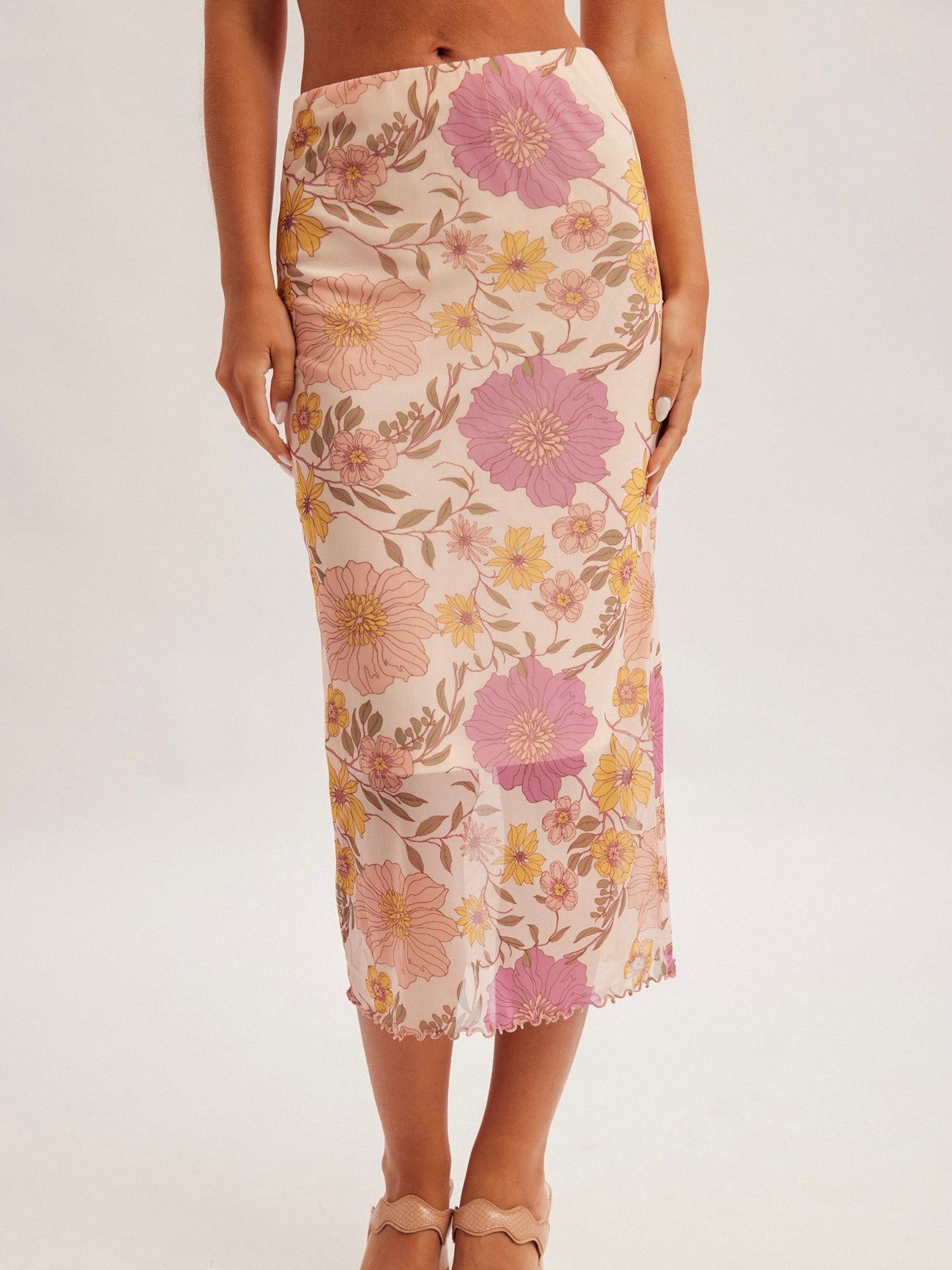 Floral patterned skirt worn by a person on a white background