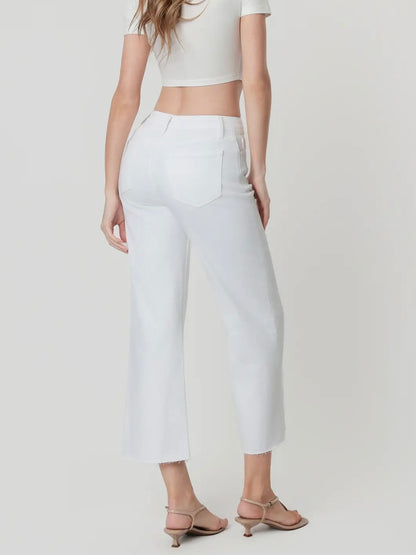 Person wearing white pants and a white top on a plain background
