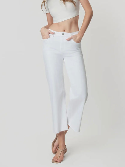 Person wearing white pants and a white top on a plain background