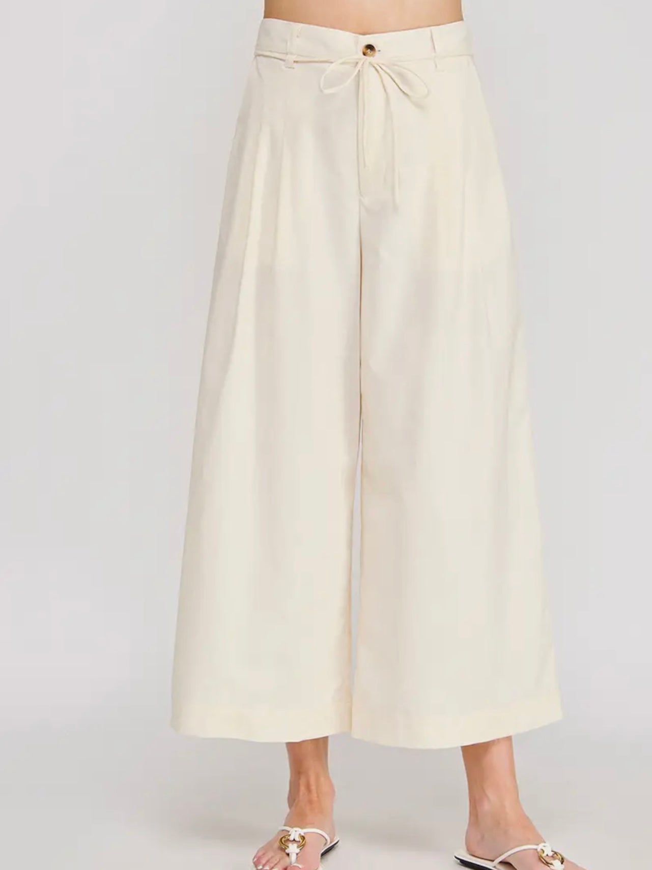 Beige wide-leg pants on a white background
