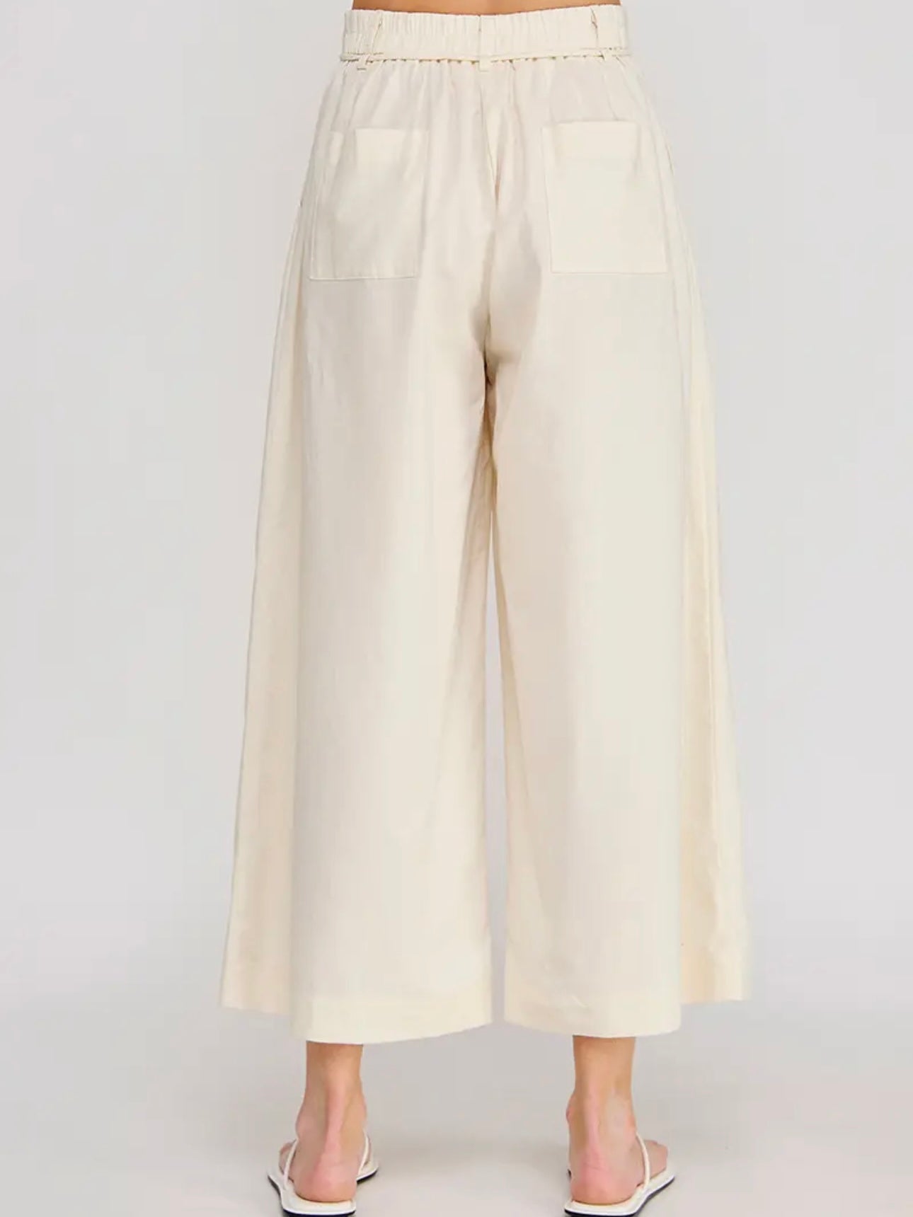 Beige wide-leg pants on a white background