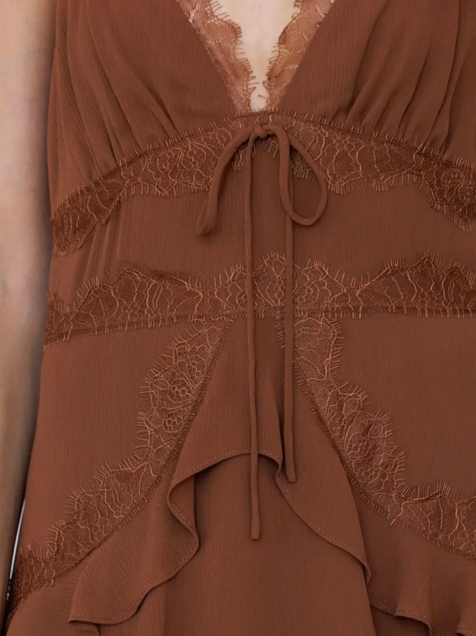 Close-up of a brown dress with lace trim, a deep V-neckline, and a drawstring tie at the waist.