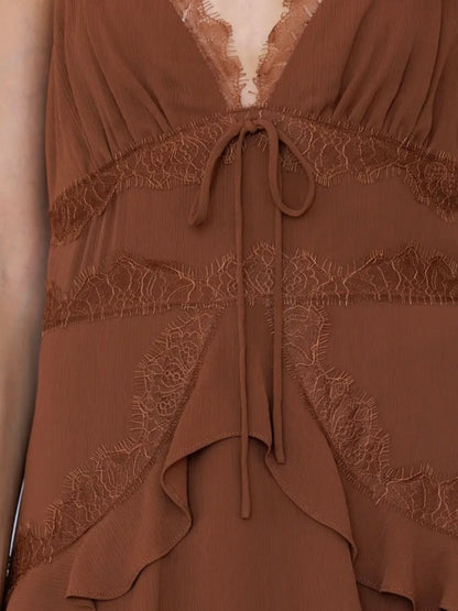 Close-up of a brown dress with lace trim, a deep V-neckline, and a drawstring tie at the waist.