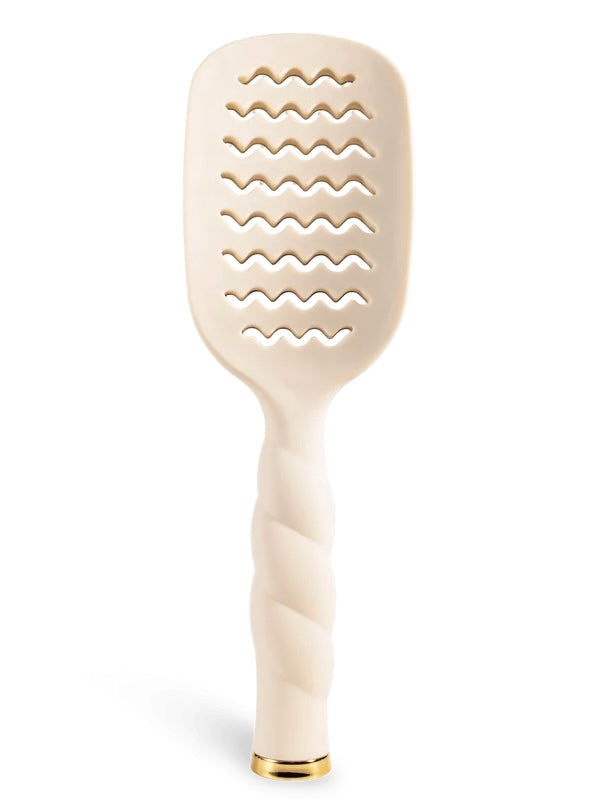 An off-white hairbrush with a twisted handle and a gold accent at the base, shown on a clean white background.