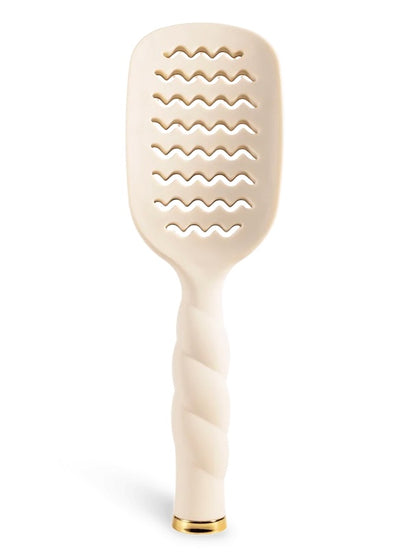 An off-white hairbrush with a twisted handle and a gold accent at the base, shown on a clean white background.