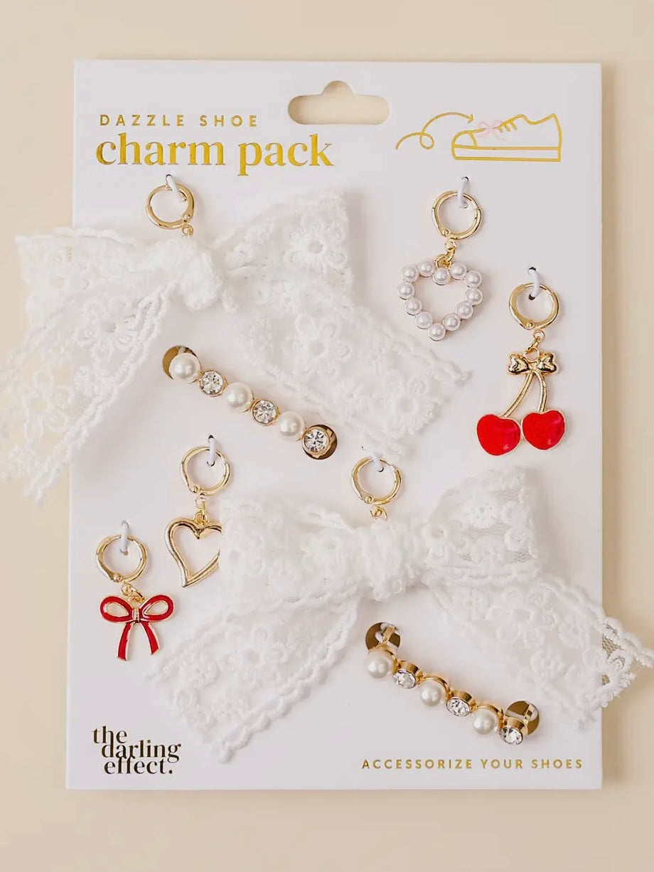 Charm pack with various charms on a white card, featuring 'The Darling Effect' branding.