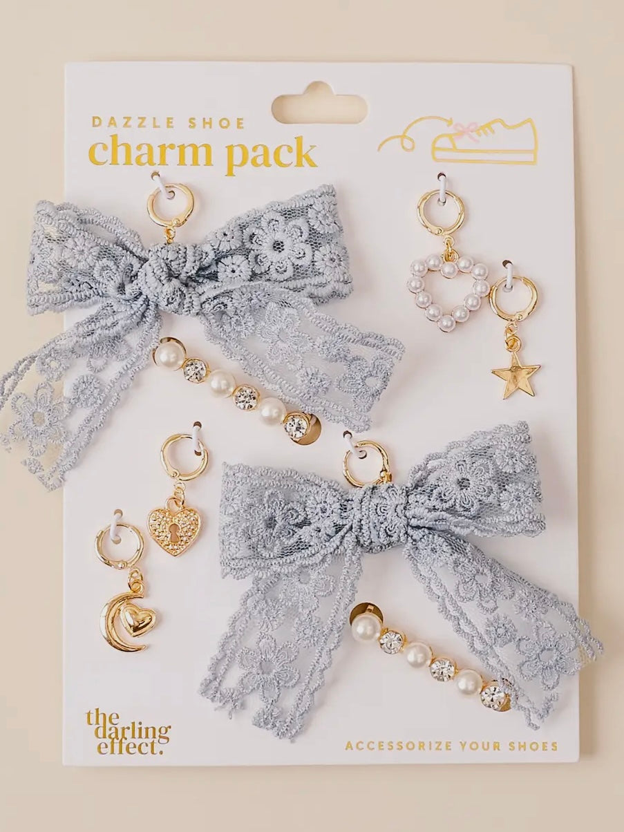 Charm pack with lace bow and decorative charms on a white card, featuring 'The Darling Effect' brand.