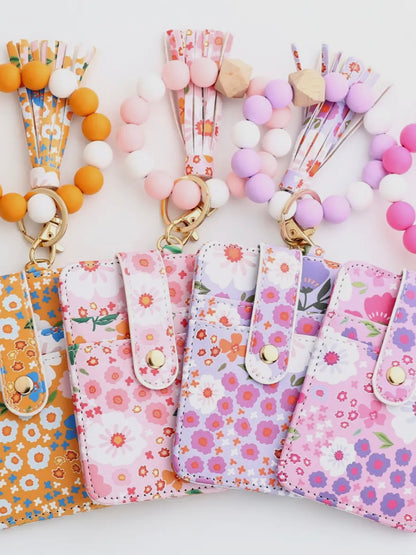 Floral phone cases with colorful lanyards on a white background