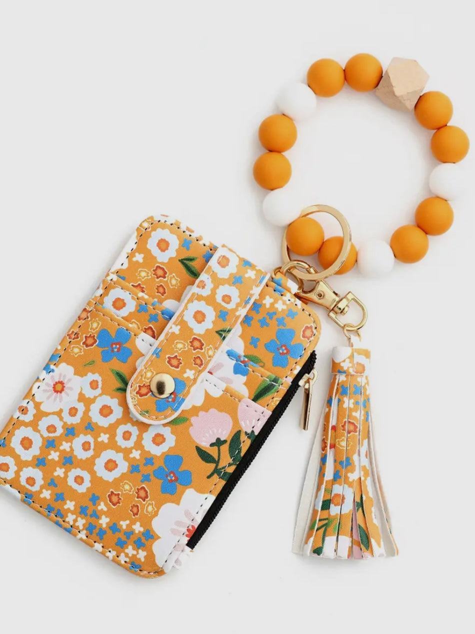 Floral-patterned pouch with a matching keychain on a white background