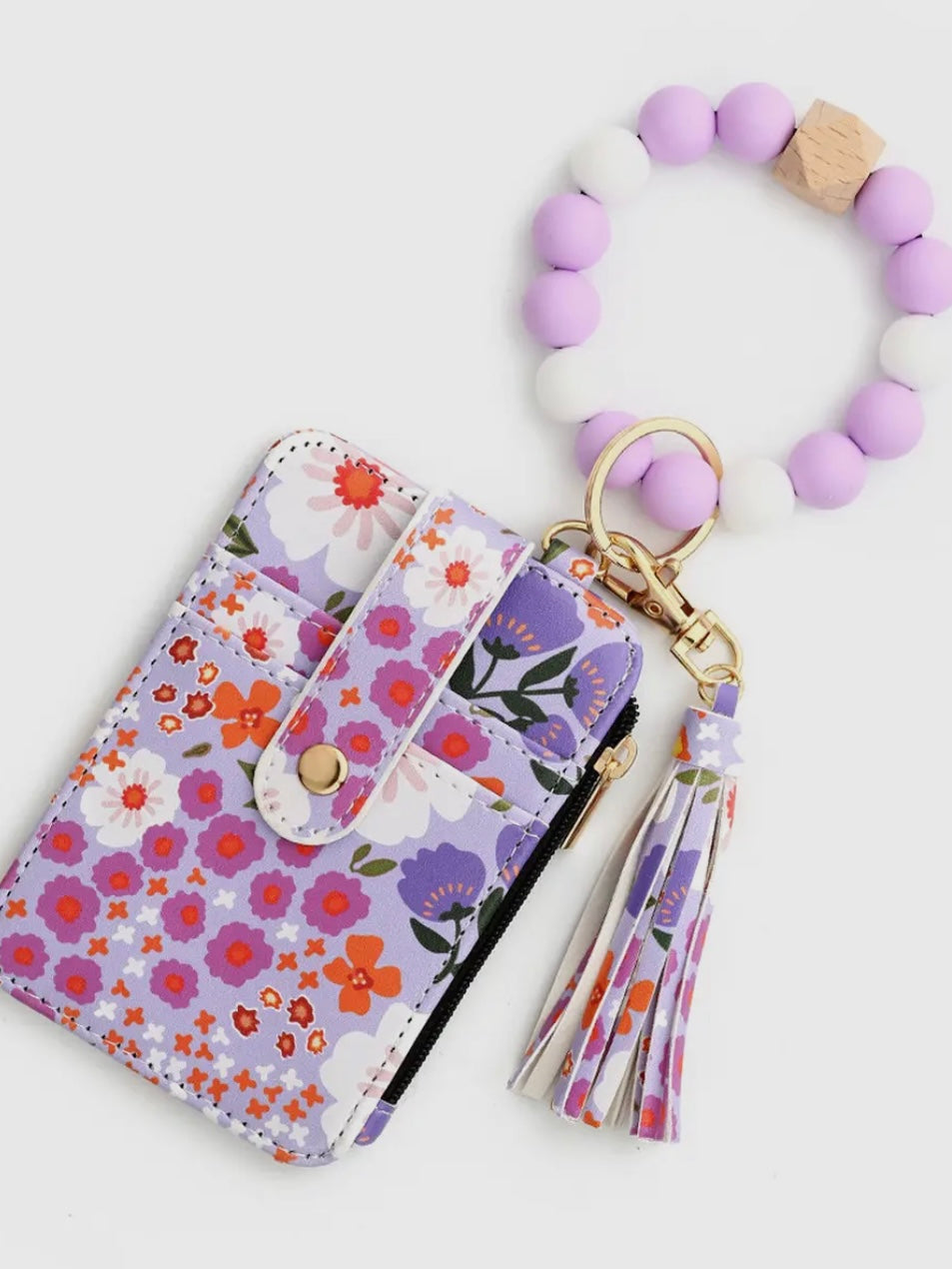 Floral-patterned pouch with a matching keychain on a white background